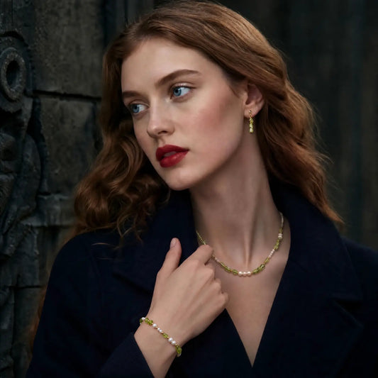 Woman wearing the peridot and pearl necklace with matching bracelet
