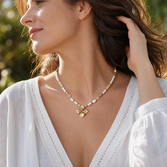 Woman wearing an opal bloom necklace with a white V-neck top