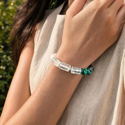 Styled wrist view of the Verdant Circuit Malachite & Onyx Bracelet with green malachite, black onyx, clear quartz, pearl, and spotted stone sections