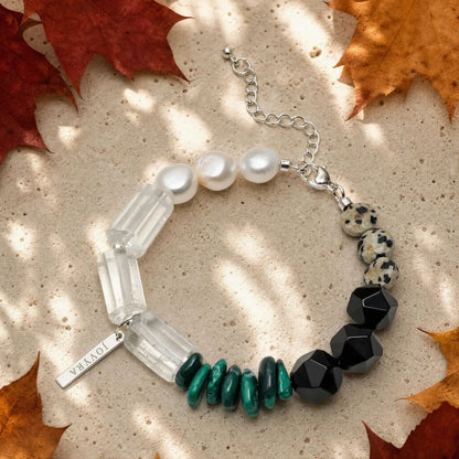 Full view of the Verdant Circuit Malachite & Onyx Bracelet showing green malachite, black onyx, clear quartz, pearl, and spotted stone sections