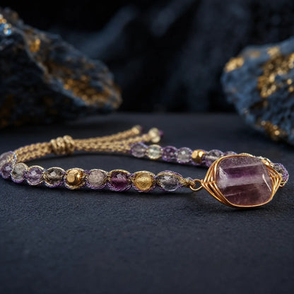 Wire-wrapped violet fluorite stone and braided bracelet detail