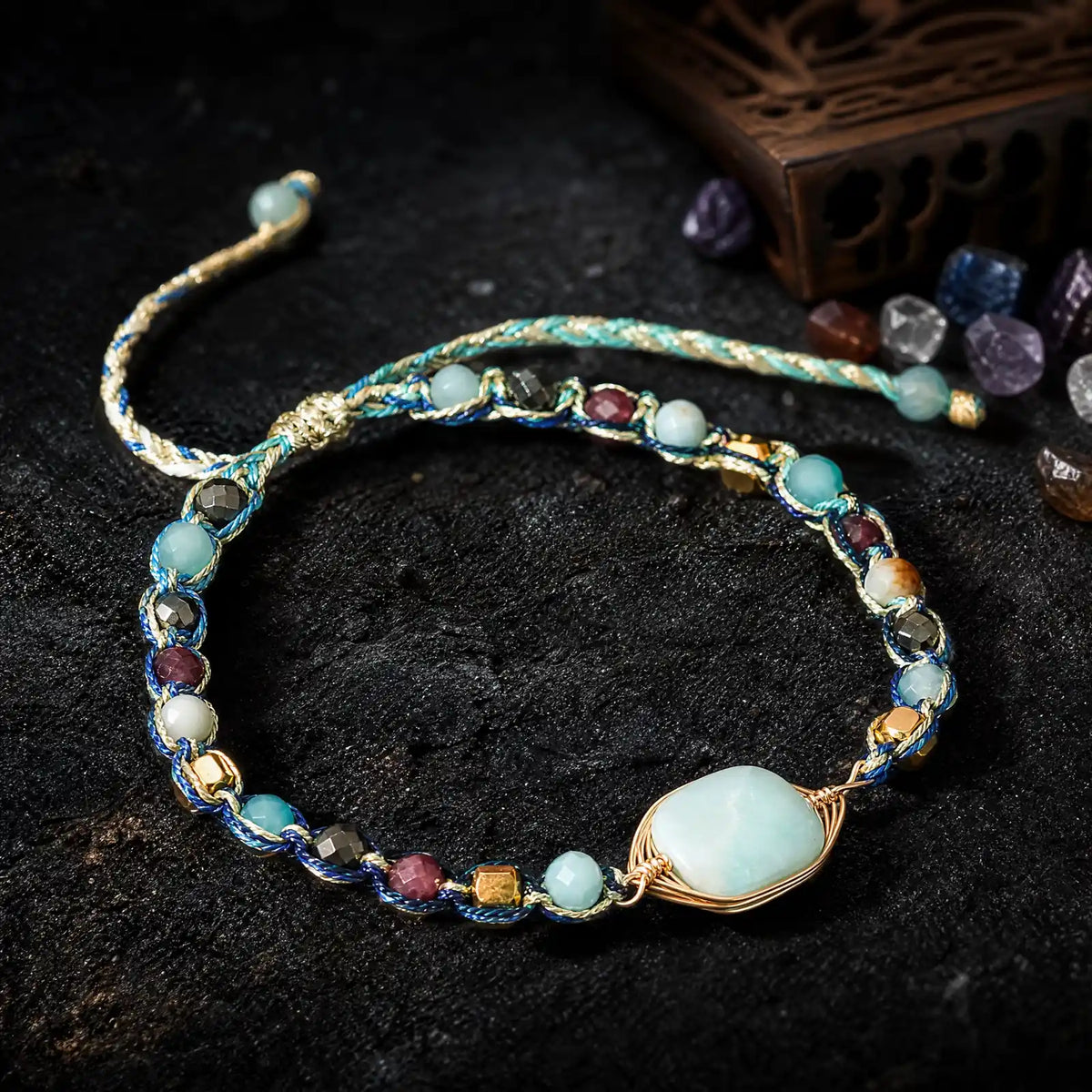 Natural stone braided bracelets displayed together on dark stone