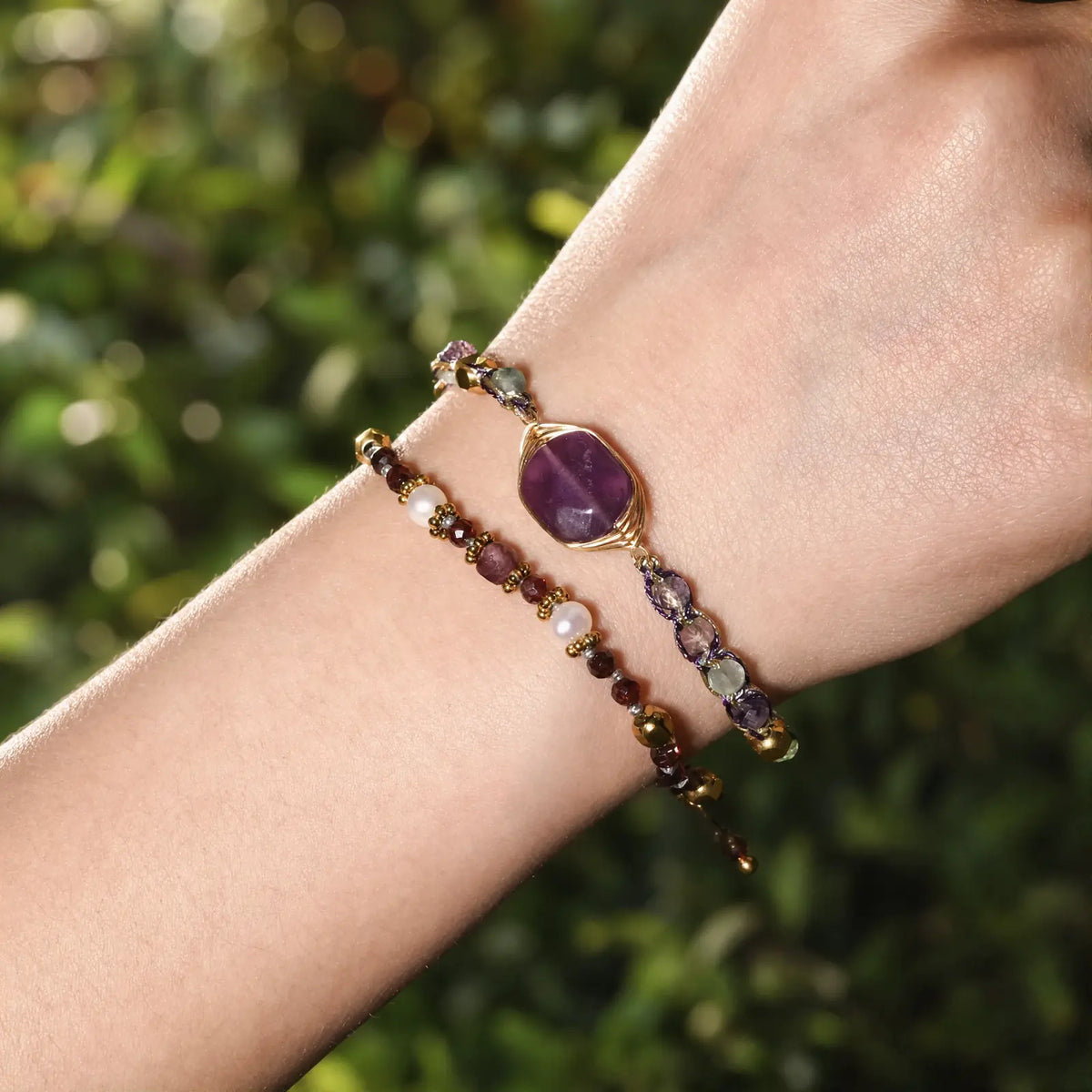 Violet fluorite braided bracelet worn in warm garden light