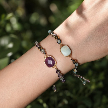 Fluorite and amazonite bracelets layered in outdoor light