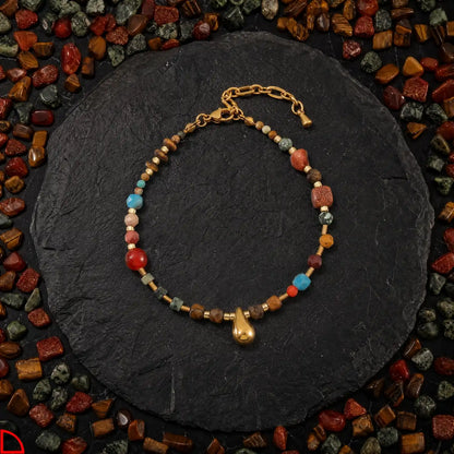 Tiger eye drop mixed stone charm bracelet on dark slate