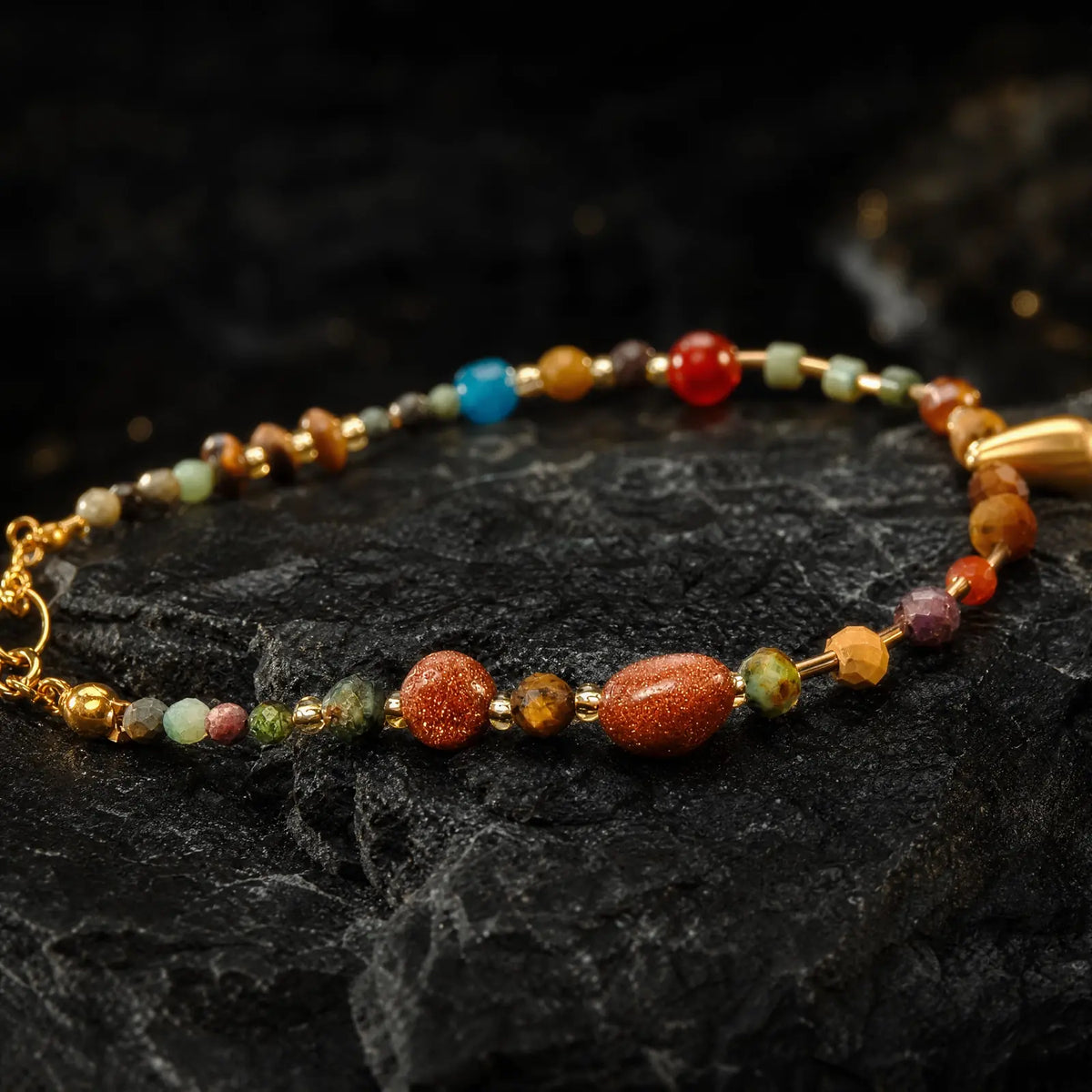 Mixed stone beads and amber leaf charm in close view
