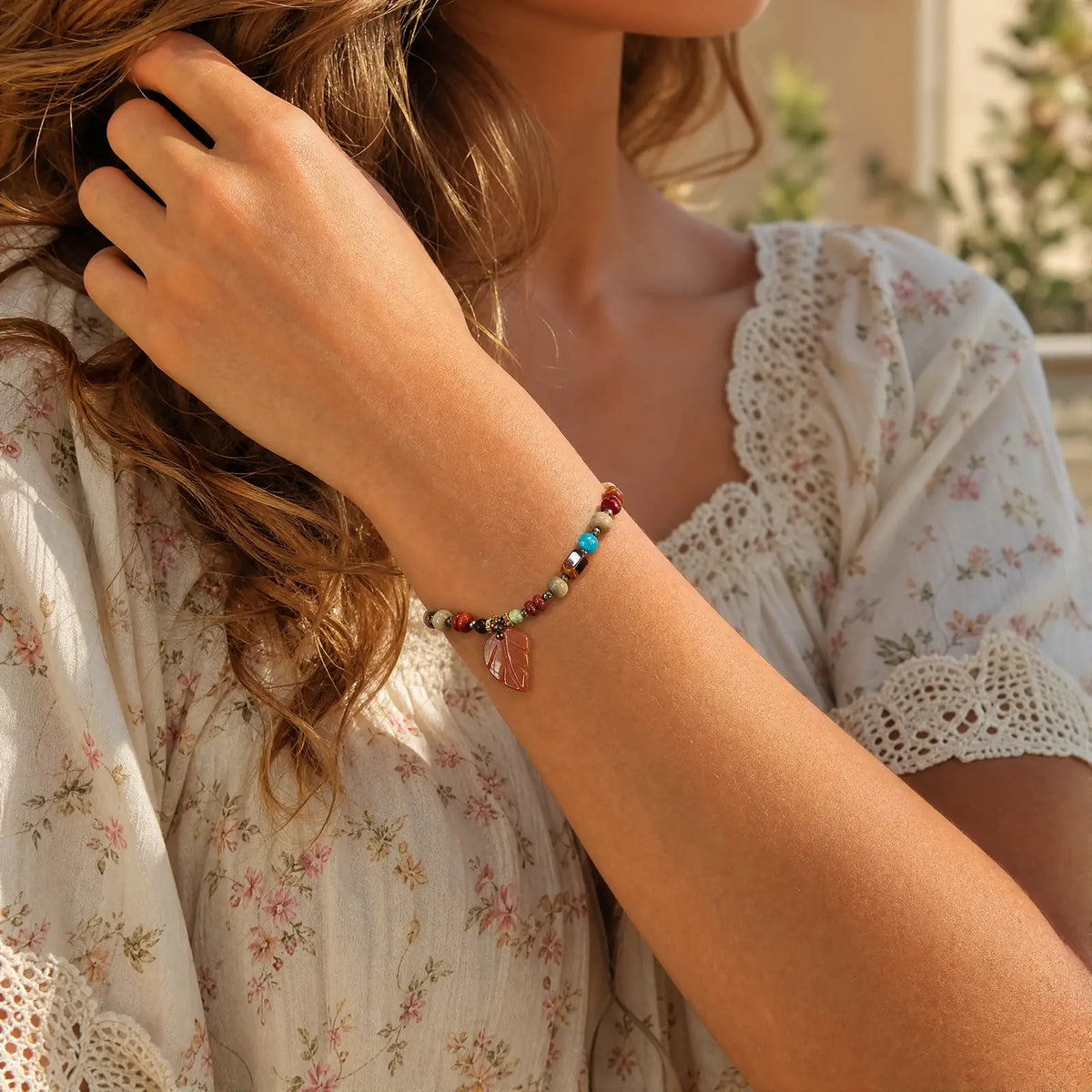 Amber leaf mixed stone bracelet in a relaxed garden setting
