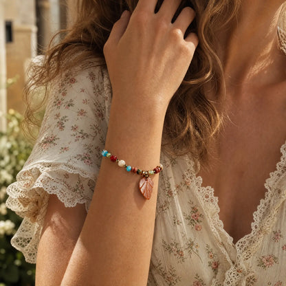 Amber leaf charm bracelet worn with a floral blouse