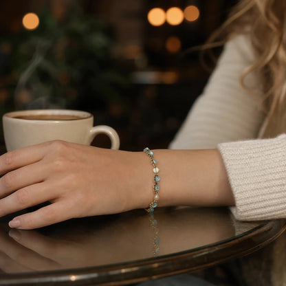 Blue cat's-eye bracelet worn at a café table