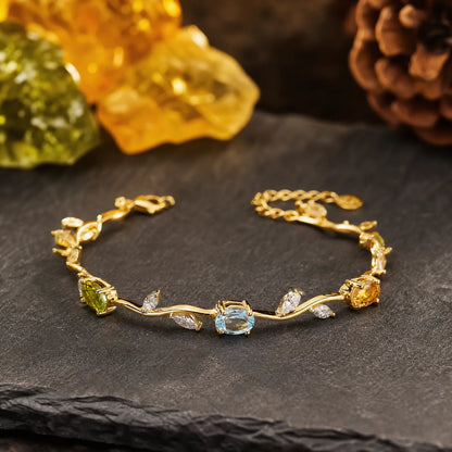 Curved multi-stone vine bracelet displayed on dark stone