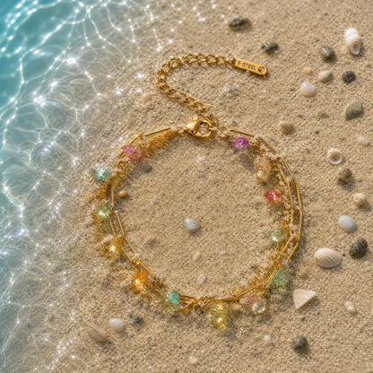 Colorful stainless steel strand arranged in shallow water on sand