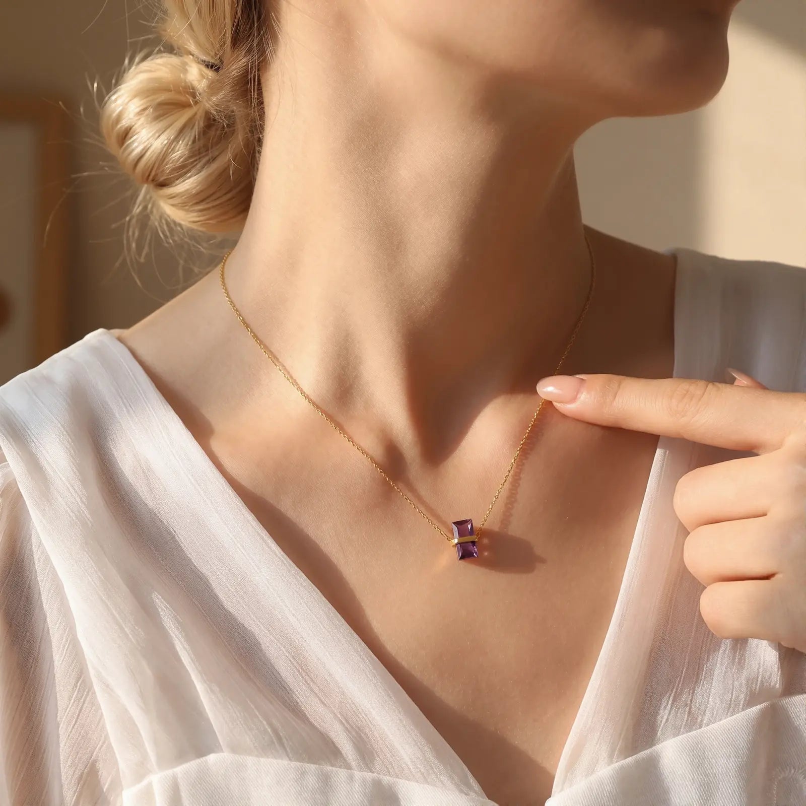 Diamond Birthstone Pendant Necklace worn at the neckline, lifestyle view 1.