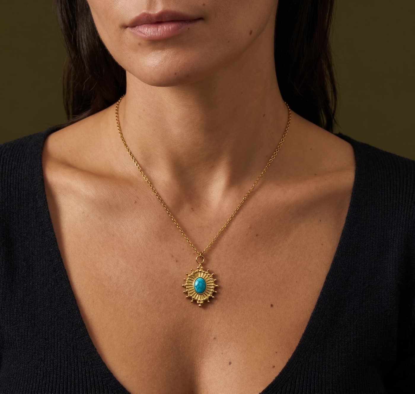 Oval natural turquoise pendant necklace worn with a black neckline