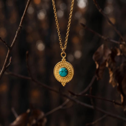 Small round natural turquoise pendant necklace with gold-tone textured frame