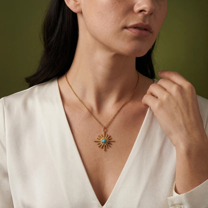 Starburst natural turquoise pendant necklace worn with a white blouse
