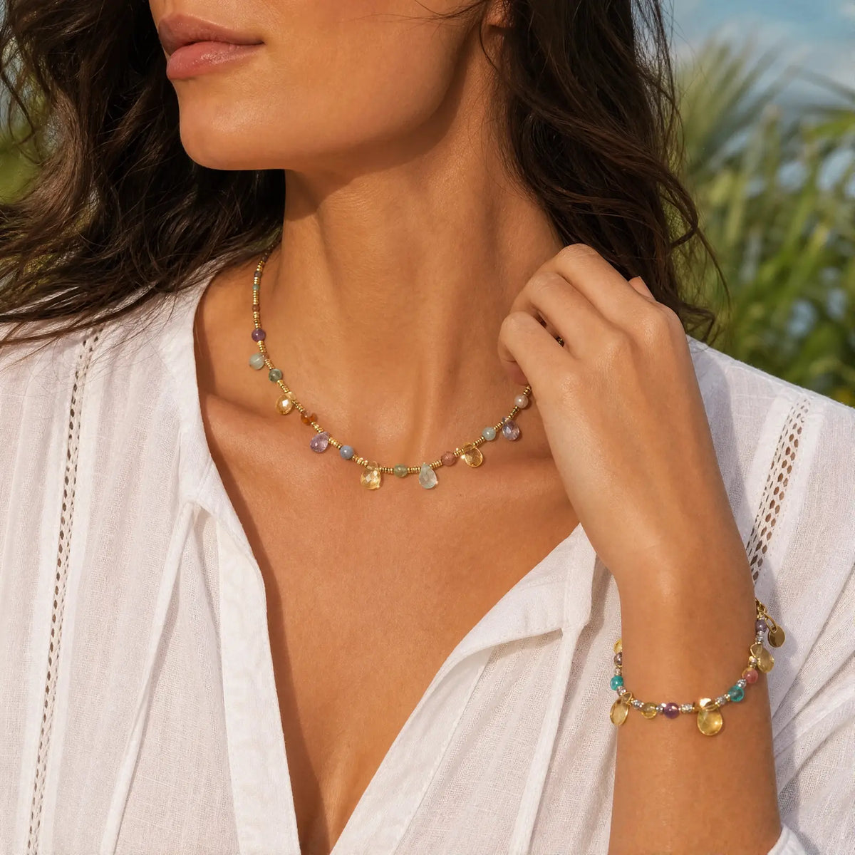 Natural stone necklace and bracelet worn with a white blouse