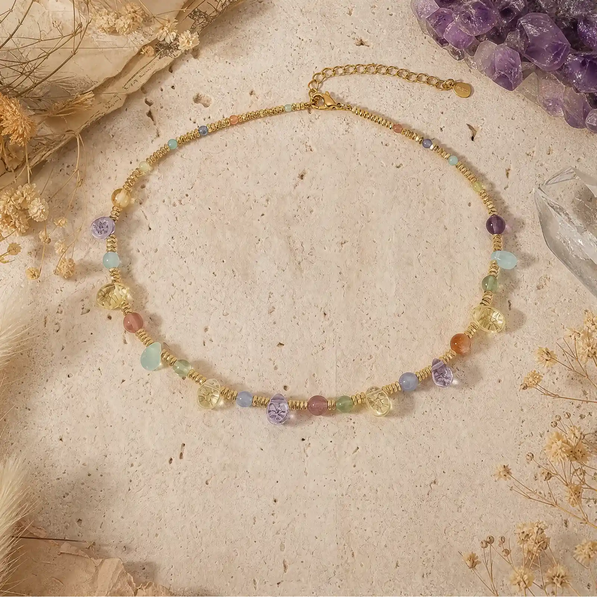 Natural stone beaded necklace with warm gold-tone details on a light surface