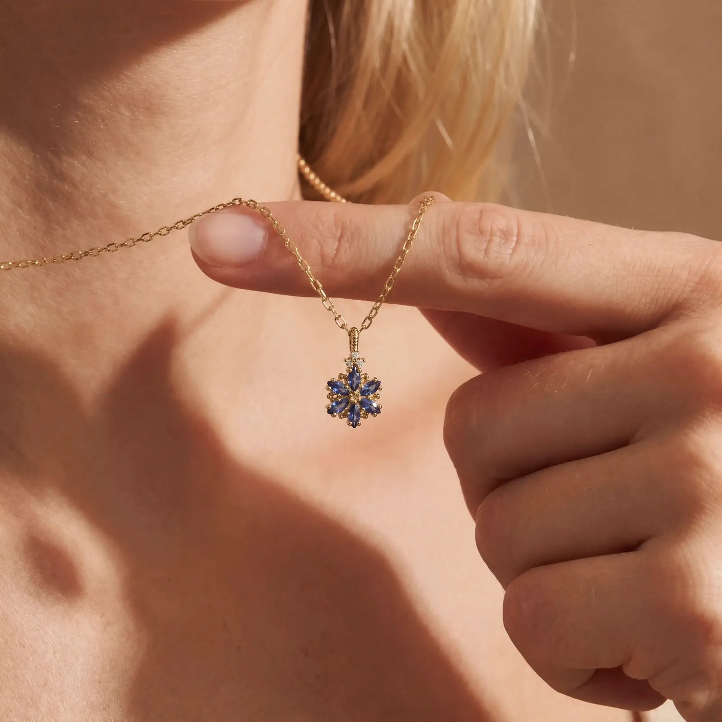 Blue Zircon Petal Cluster Necklace worn at the neckline, lifestyle view 1.