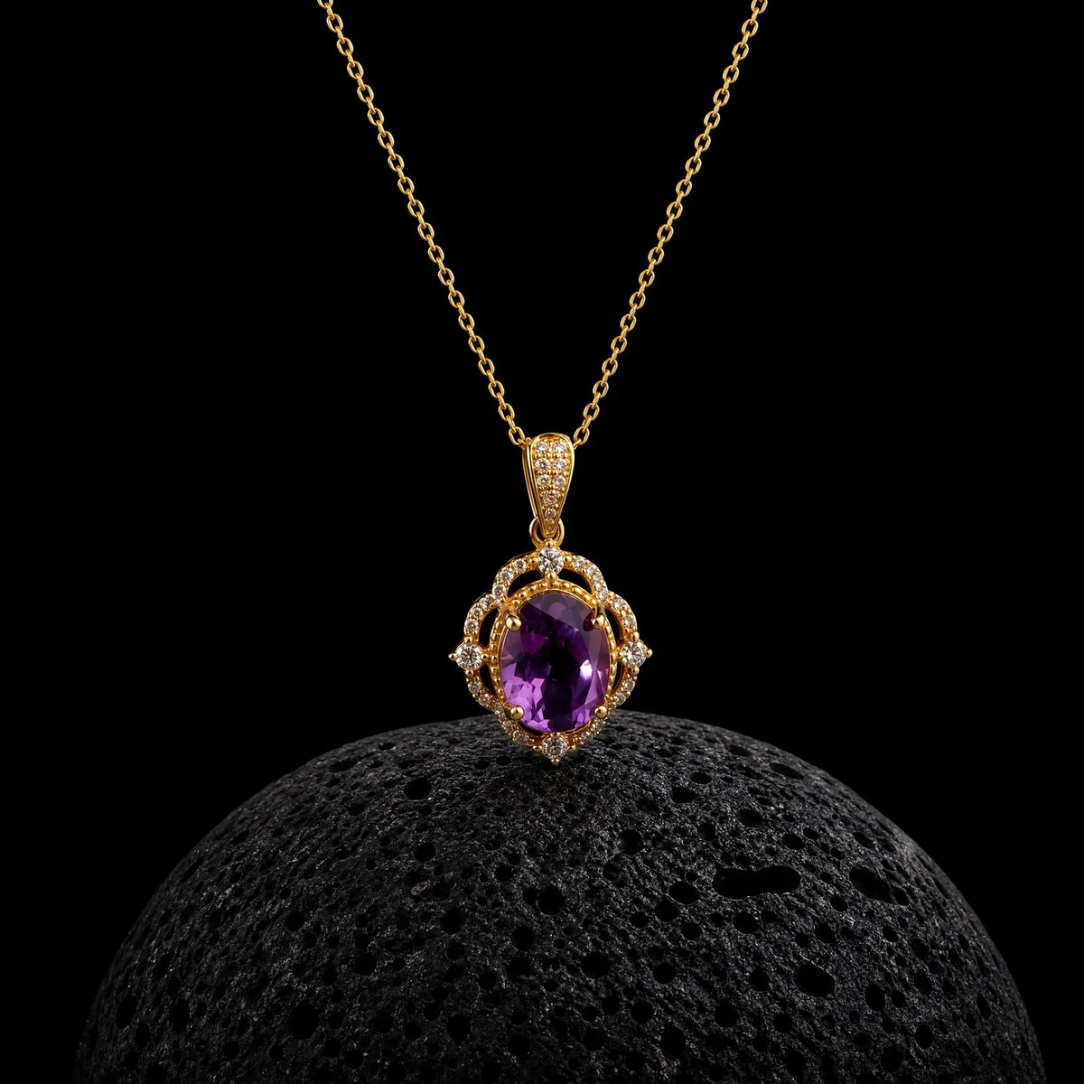 Oval amethyst pendant framed by a detailed gold-tone halo