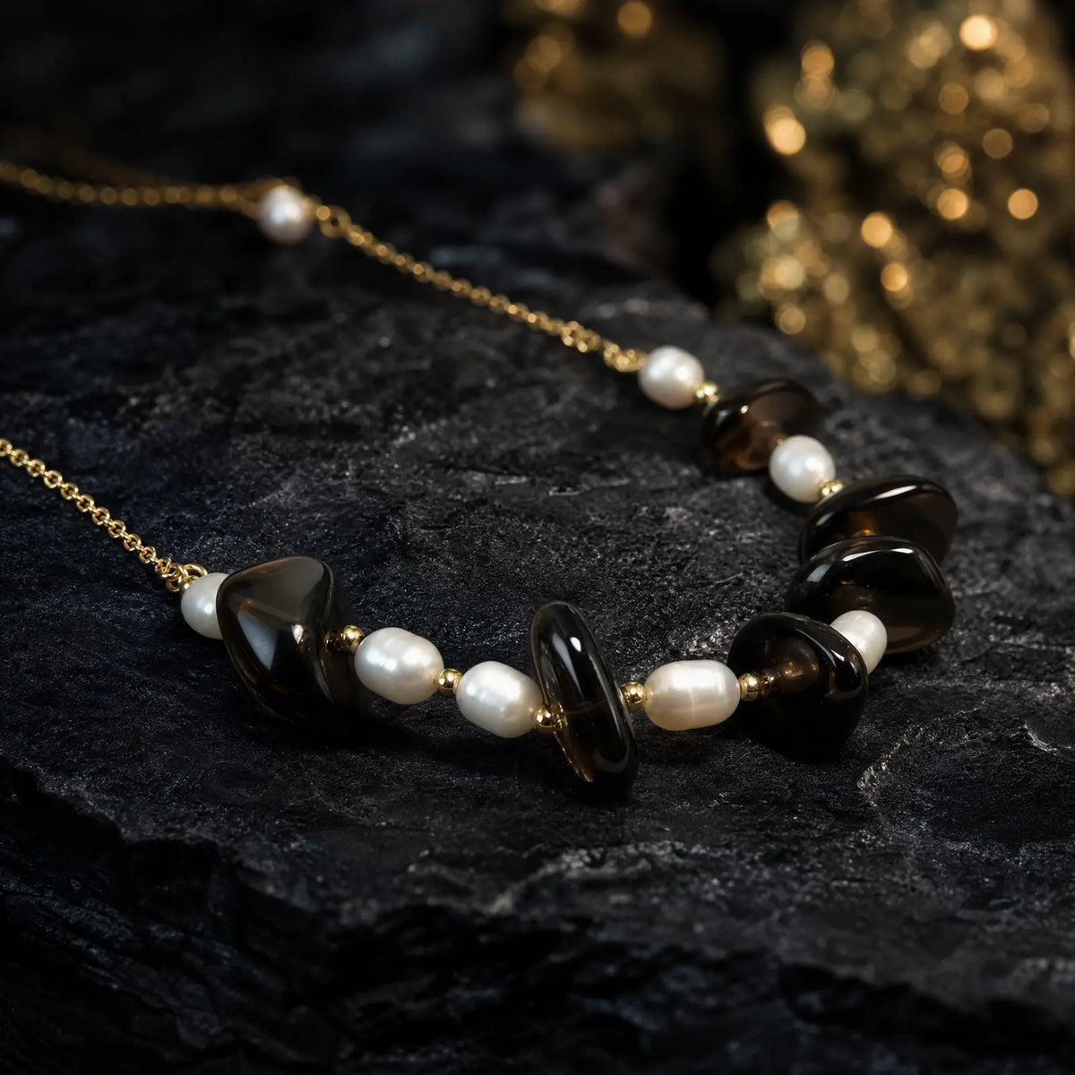 Close view of smoky quartz beads and freshwater pearls on a gold-tone necklace