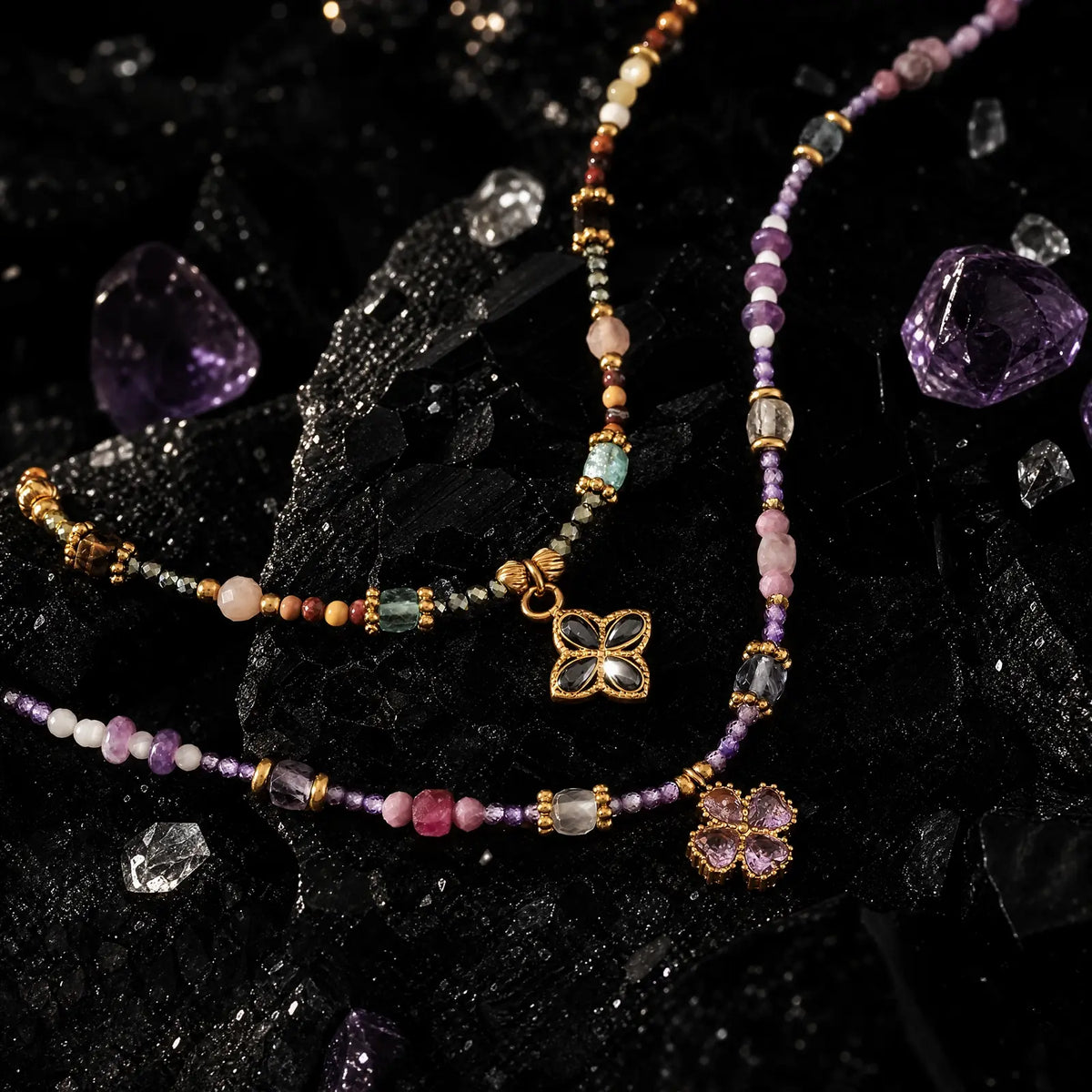 Lilac and tiger eye clover necklaces displayed together in natural light