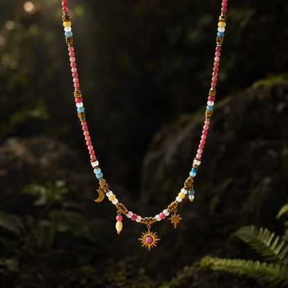 Rose Celestial natural stone necklace on a dark botanical background