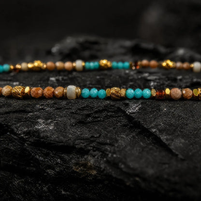 Celestial necklace beadwork and gold-tone details in close-up