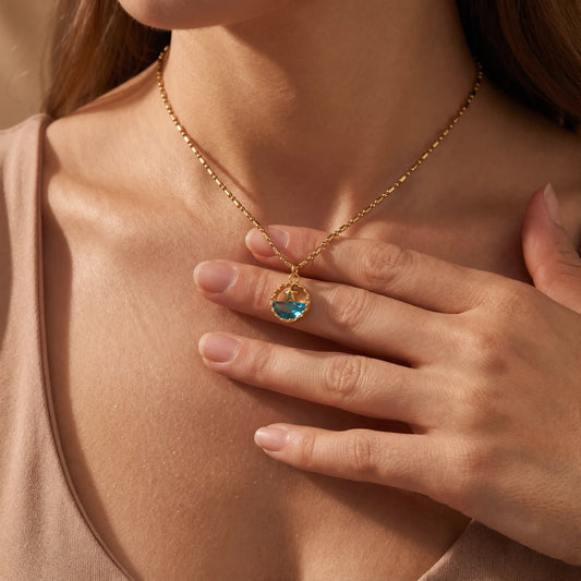 Ocean Motif Glass Pendant Necklace worn at the neckline, lifestyle view 1.
