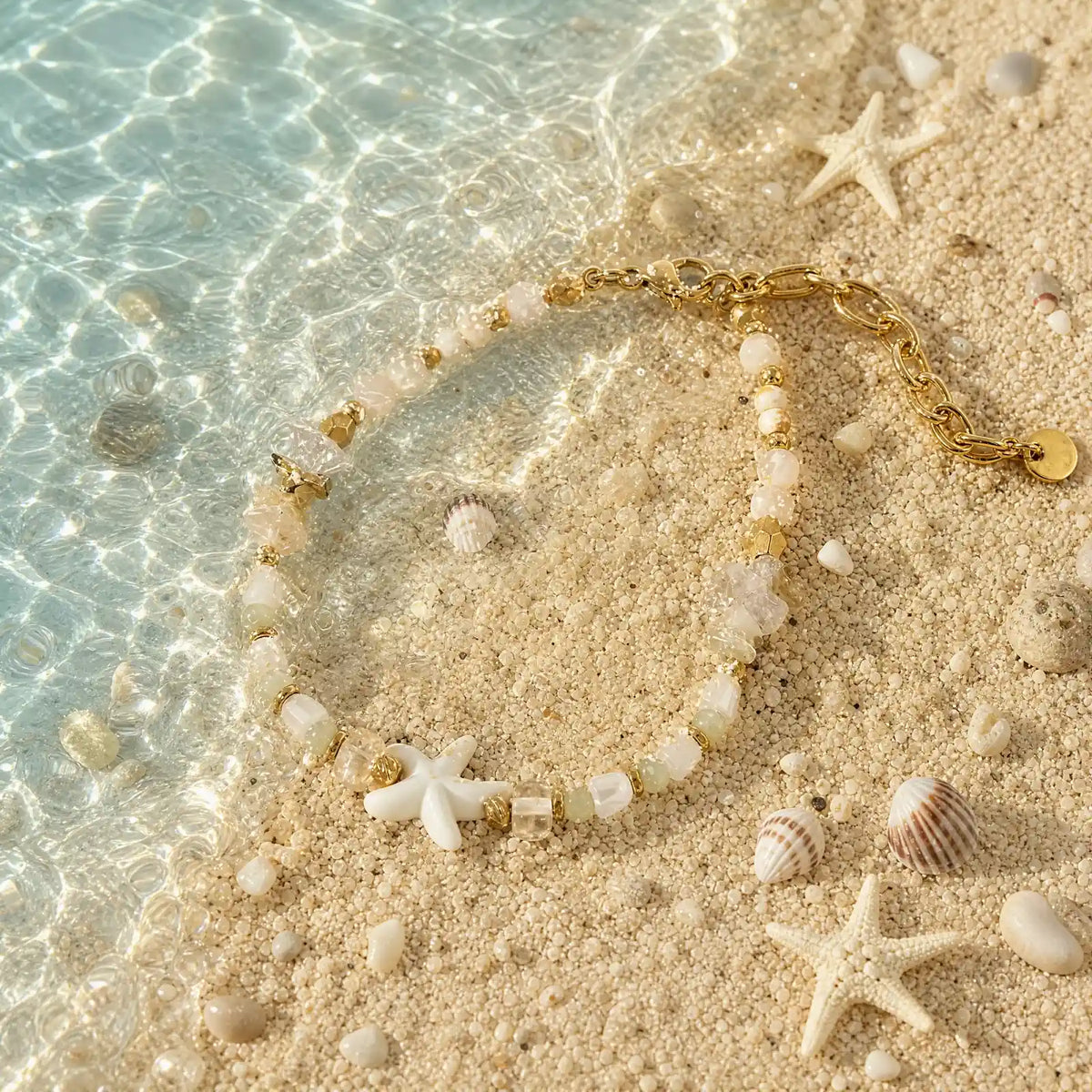 Starfish natural stone necklace styled in shallow water on sand