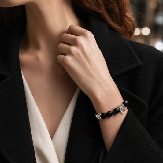 Wrist view of the Noir Facet Onyx & Pearl Bracelet with faceted black onyx, translucent included quartz, and pearl accents
