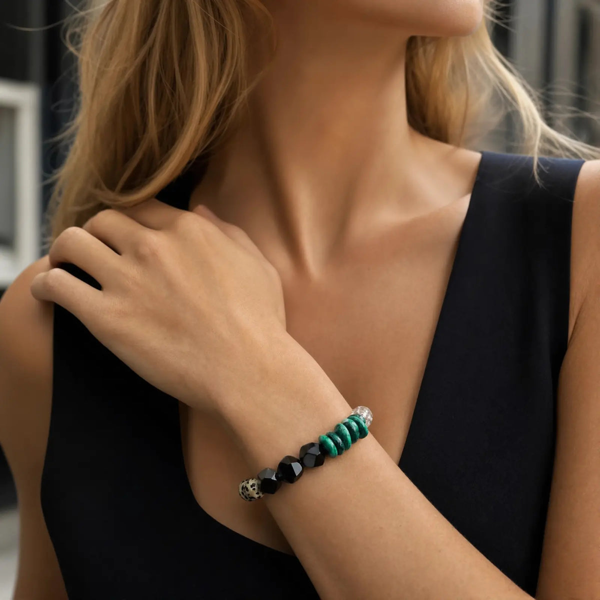 Wrist view of the Verdant Circuit Malachite & Onyx Bracelet with green malachite, black onyx, clear quartz, pearl, and spotted stone sections